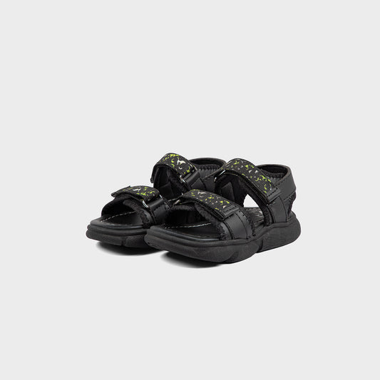 Pair of black sandals with green accents on a light gray background